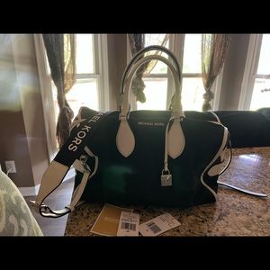 Michael Kors canvas bag with removable crossbody strap and handles.